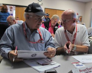 Phil Bryant (l) Mike Emich (R) and Peter Cuneo in the background, at the weather briefing