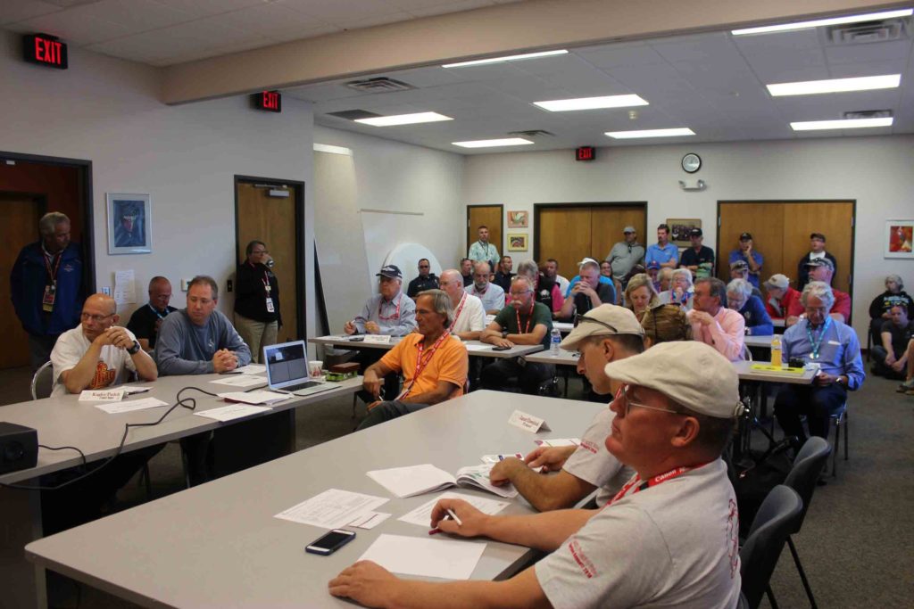 Pilots and officials at the weather briefing.